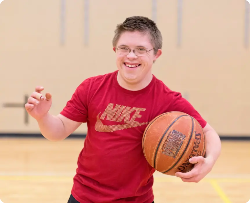 boy with basketball smiling