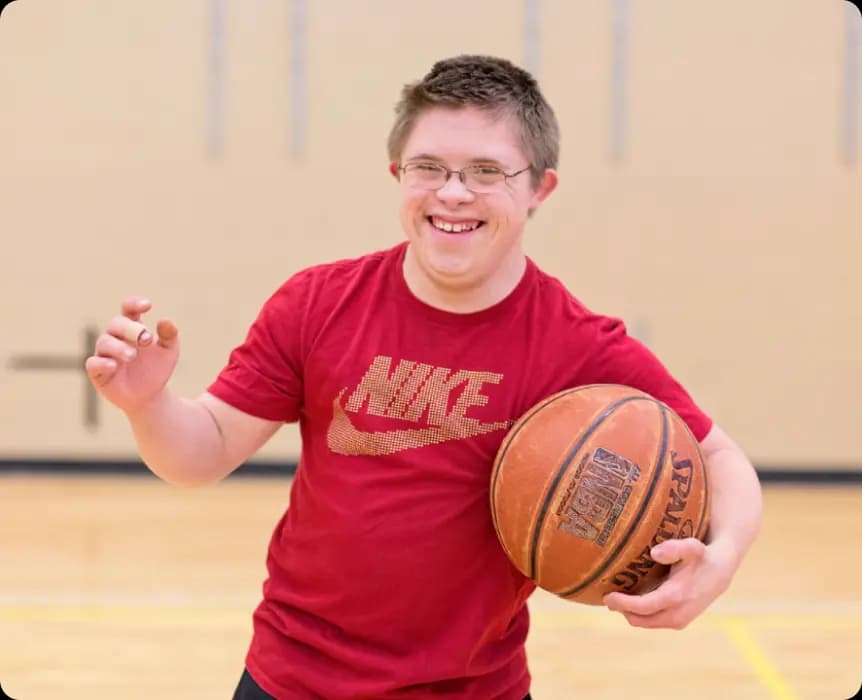 boy with basketball smiling